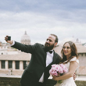 a selfie pictures of bride and groom with a stunning view of Rome